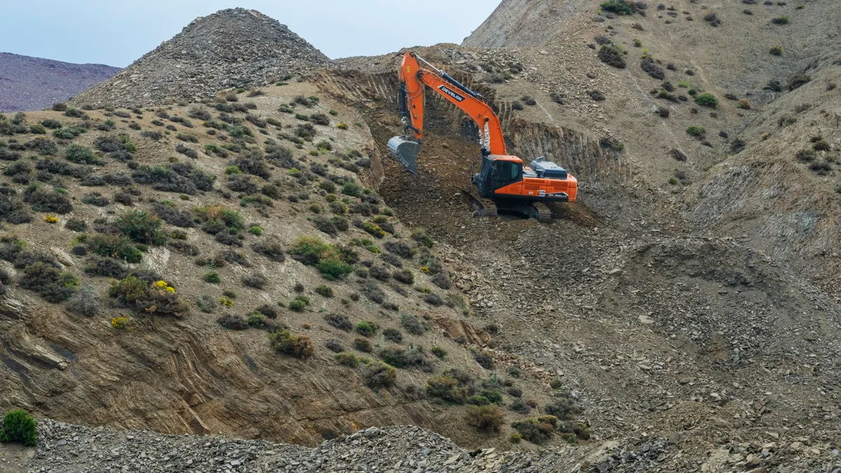 How to Improve Rocky or Compacted Soil for Xeriscaping Excavator working on a rocky hillside