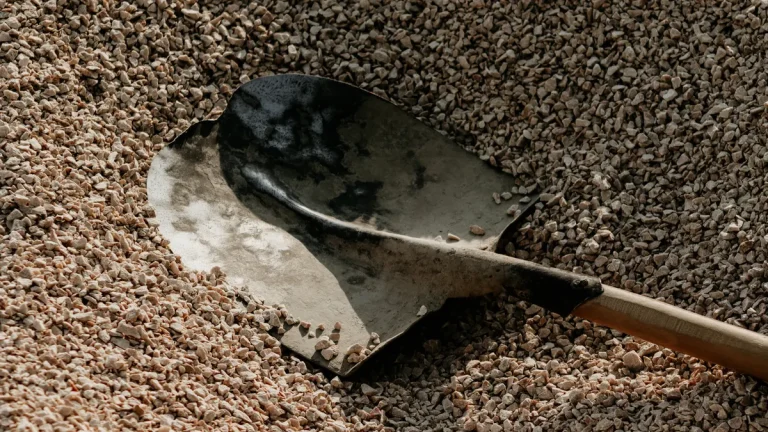 Shovel in a bed of small gravel or pebbles